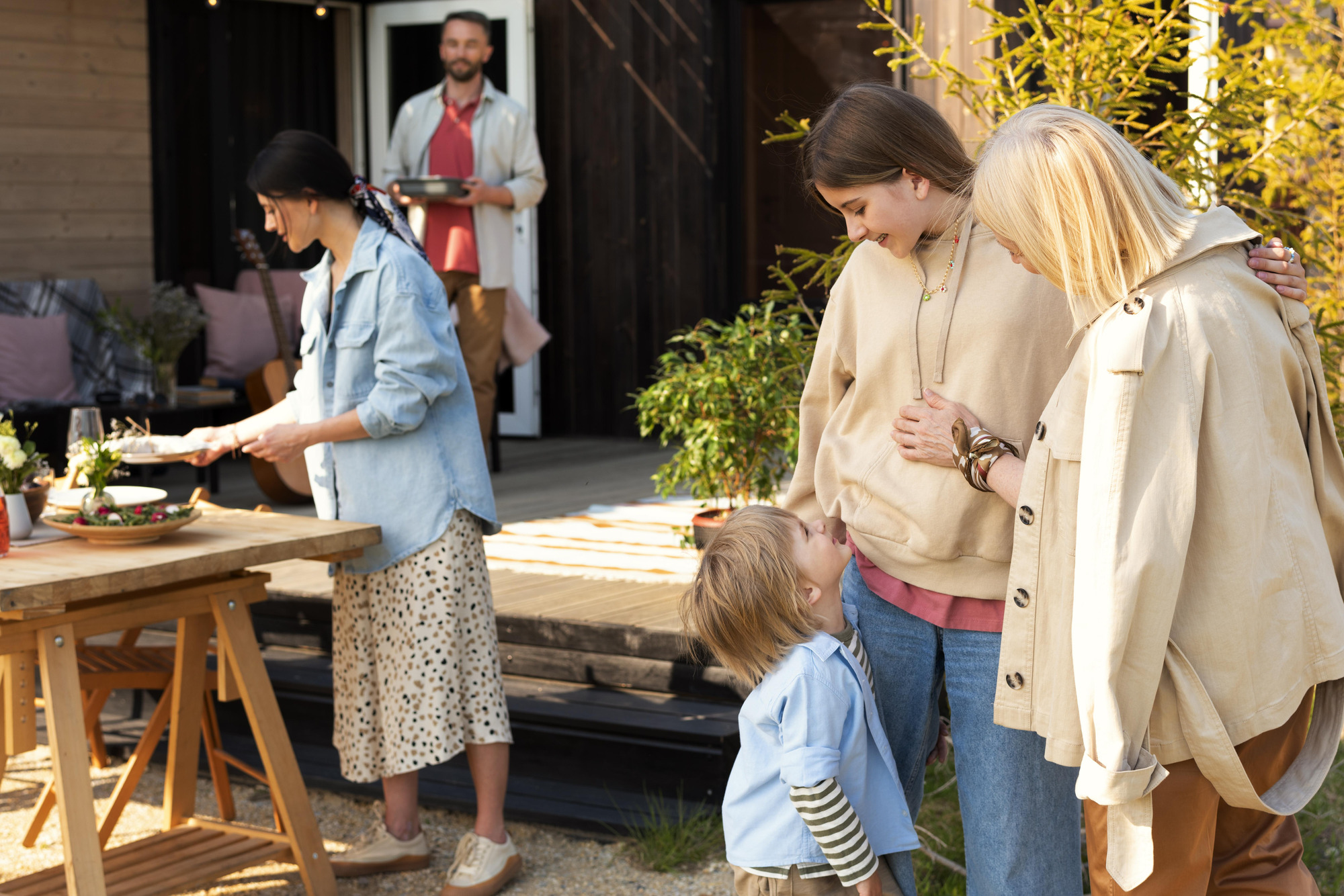 Adults and a child sharing an outdoor moment together.